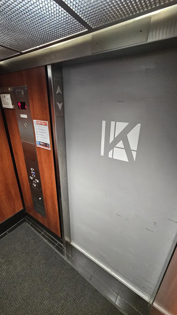 Inside the Kinected Coworking elevator with the Kinected logo