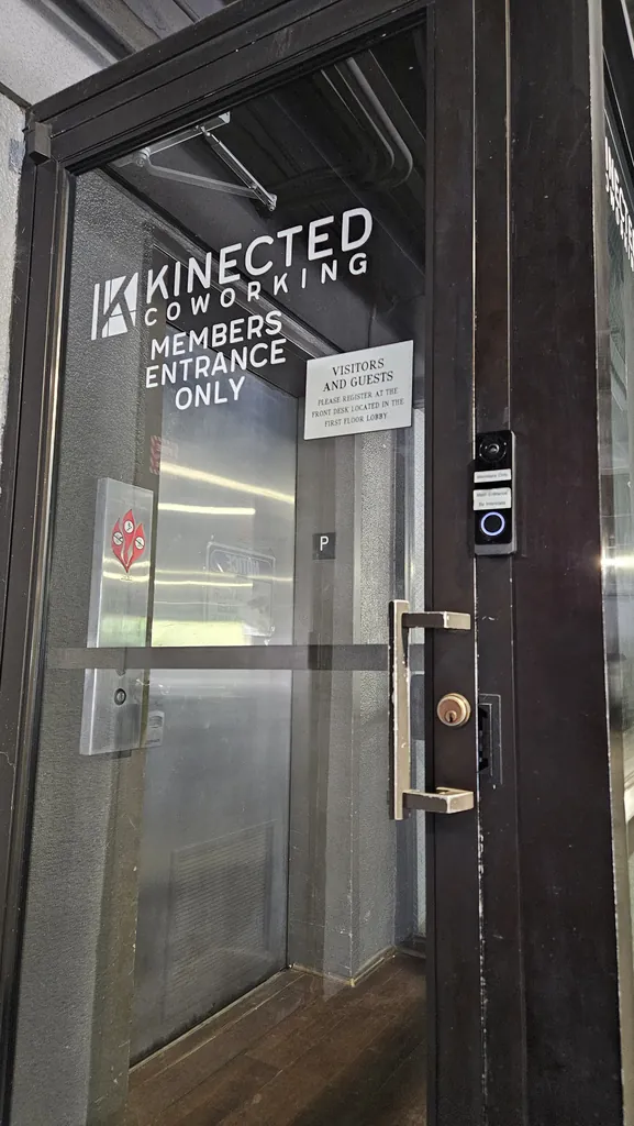 Kinected Coworking Members Entrance Only door at the parking garage with a video intercom