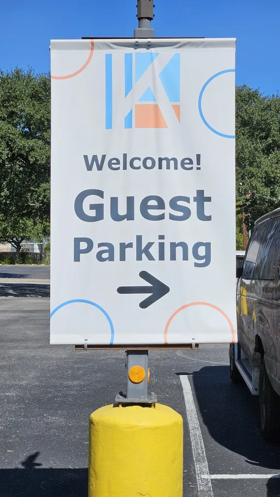 Welcome Guest Parking sign with arrow directing visitors at Kinected Coworking