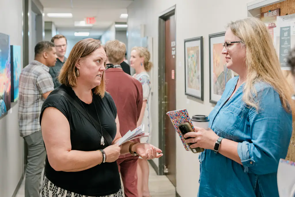 Guests chatting in the gallery hallway at the Kinected Spring Art Exhibit opening