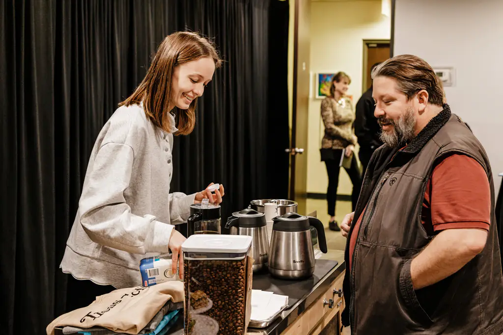 Members chatting while making coffee at the Kinected Coworking coffee bar