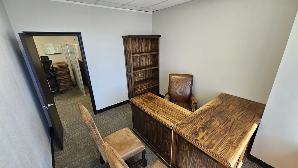 Private office in Suite 211 opening onto the shared team workspace