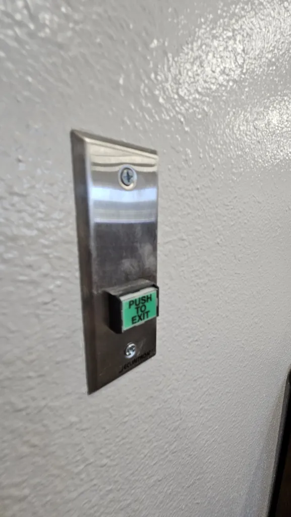 Push-to-exit button on the secured Suite 211 entry