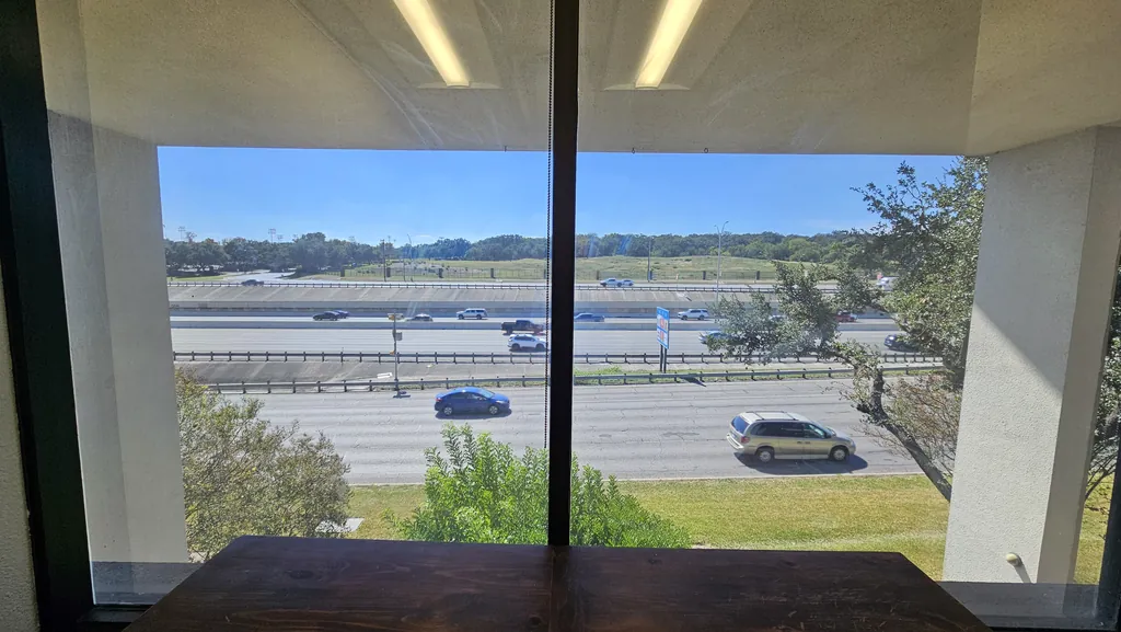 Second-floor window view from Suite 211 over Interstate 10 in northwest San Antonio