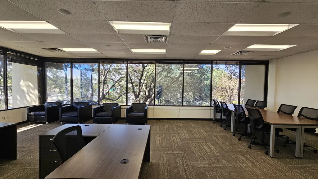 Lounge chairs along the Room 221 window wall with workstations and desks