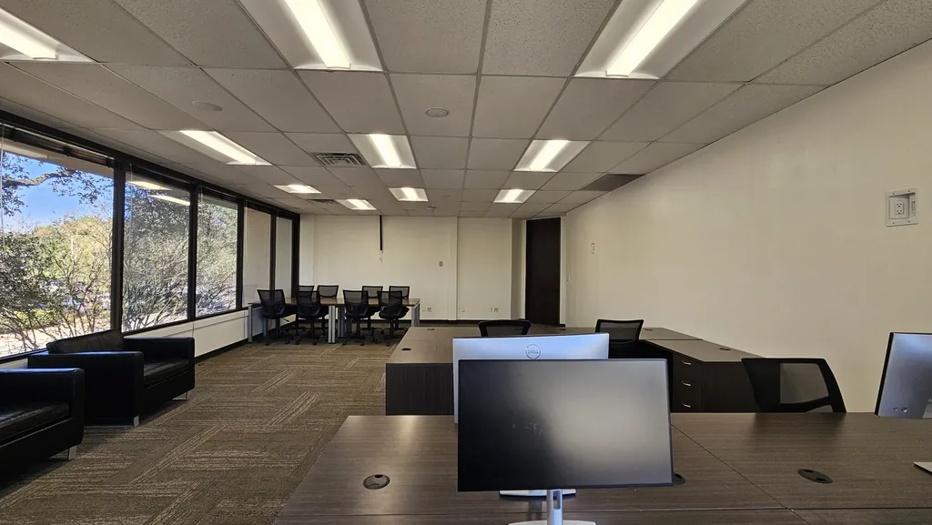 Monitor workstations in Room 221 facing the window wall