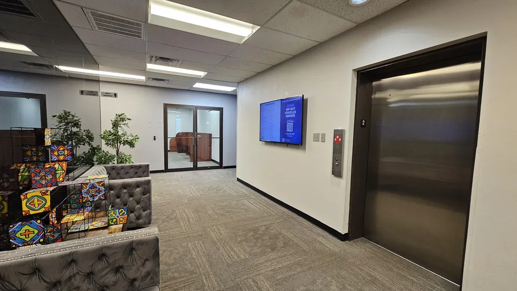 Second-floor elevator lobby and lounge seating outside Suite 211